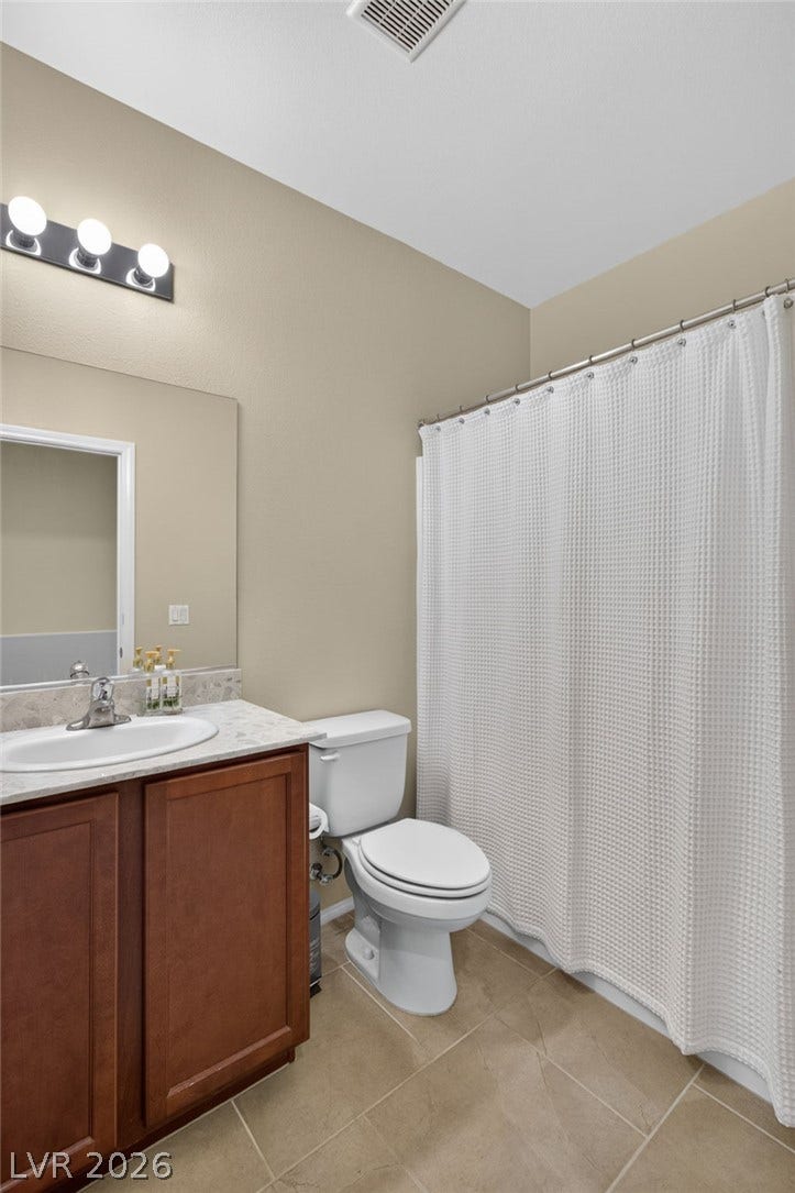 8112 Winterfell Place, Las Vegas, NV 89166 A classic vanity and neutral tile flooring anchor this functional bathroom space.