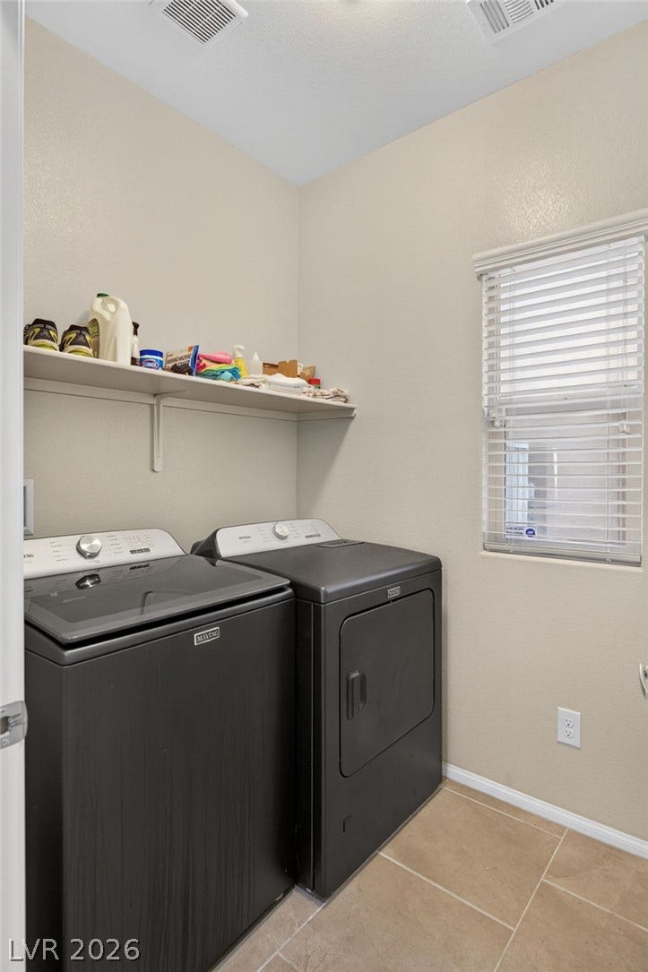 8112 Winterfell Place, Las Vegas, NV 89166 Tiled flooring and high ceilings complement this functional utility space equipped with overhead storage.