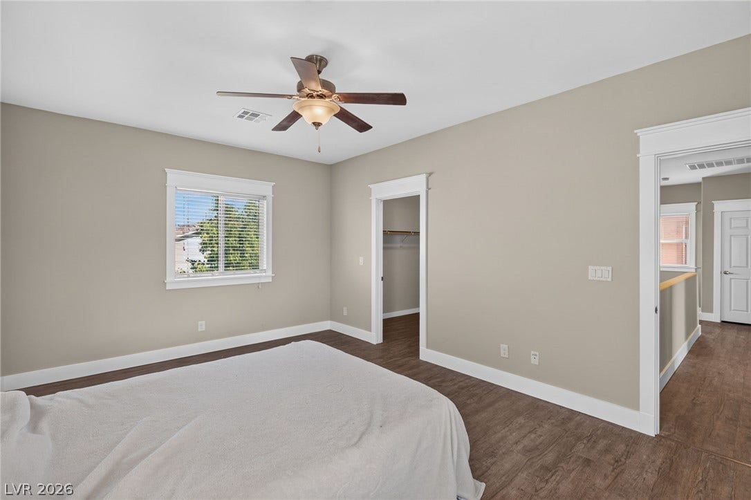 8112 Winterfell Place, Las Vegas, NV 89166 Rich wood floors and clean trim define this comfortable bedroom space.