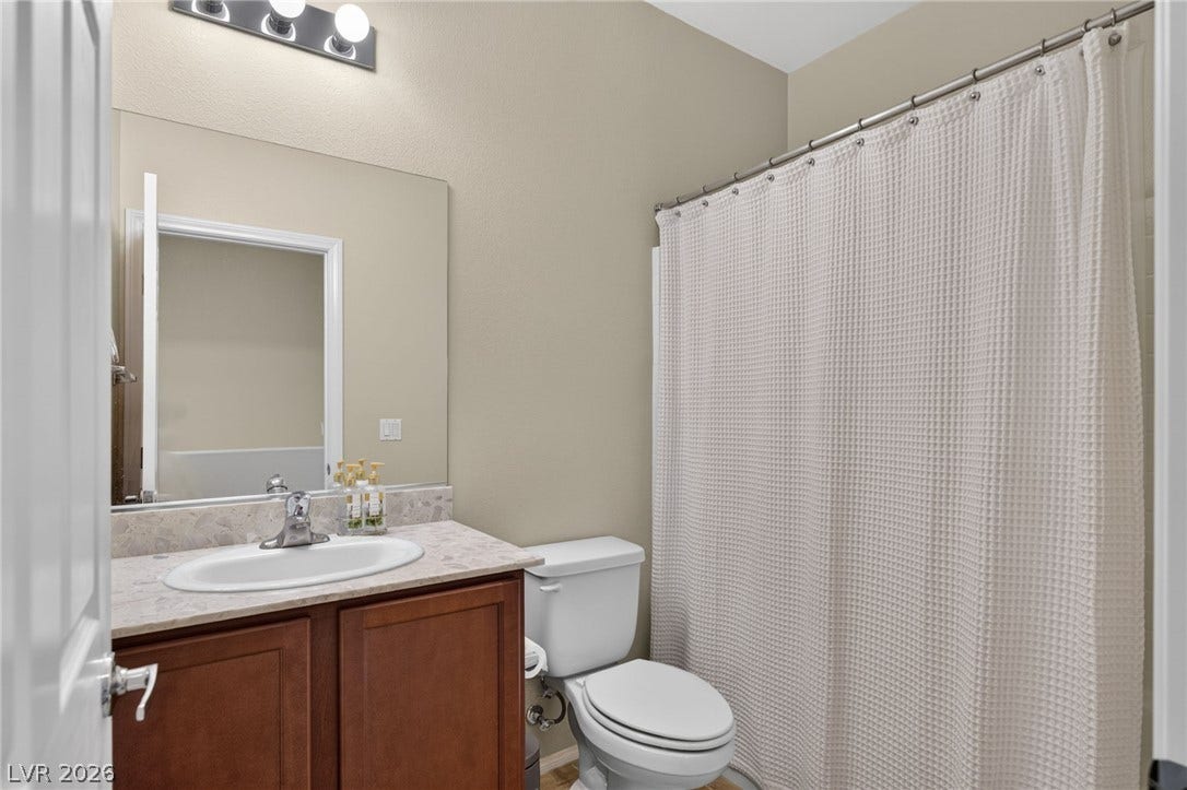 8112 Winterfell Place, Las Vegas, NV 89166 A classic vanity paired with stone counters highlights this functional bathroom space.