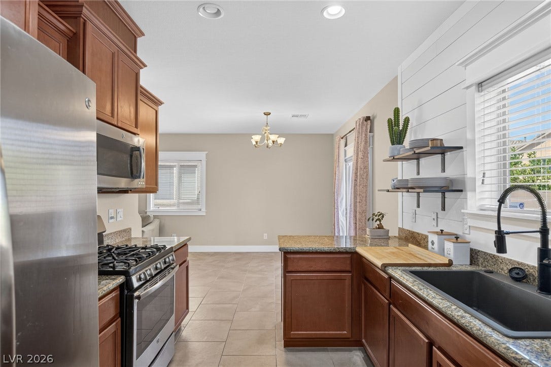 8112 Winterfell Place, Las Vegas, NV 89166 Tiled flooring flows through this bright kitchen space into an adjacent dining area.