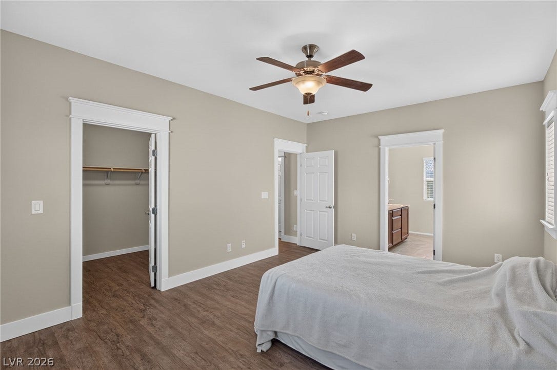 8112 Winterfell Place, Las Vegas, NV 89166 Rich wood-inspired floors and classic white trim define this comfortable private suite.