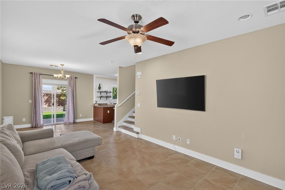 8112 Winterfell Place, Las Vegas, NV 89166 An open layout connects the tiled living space directly to the kitchen and patio.