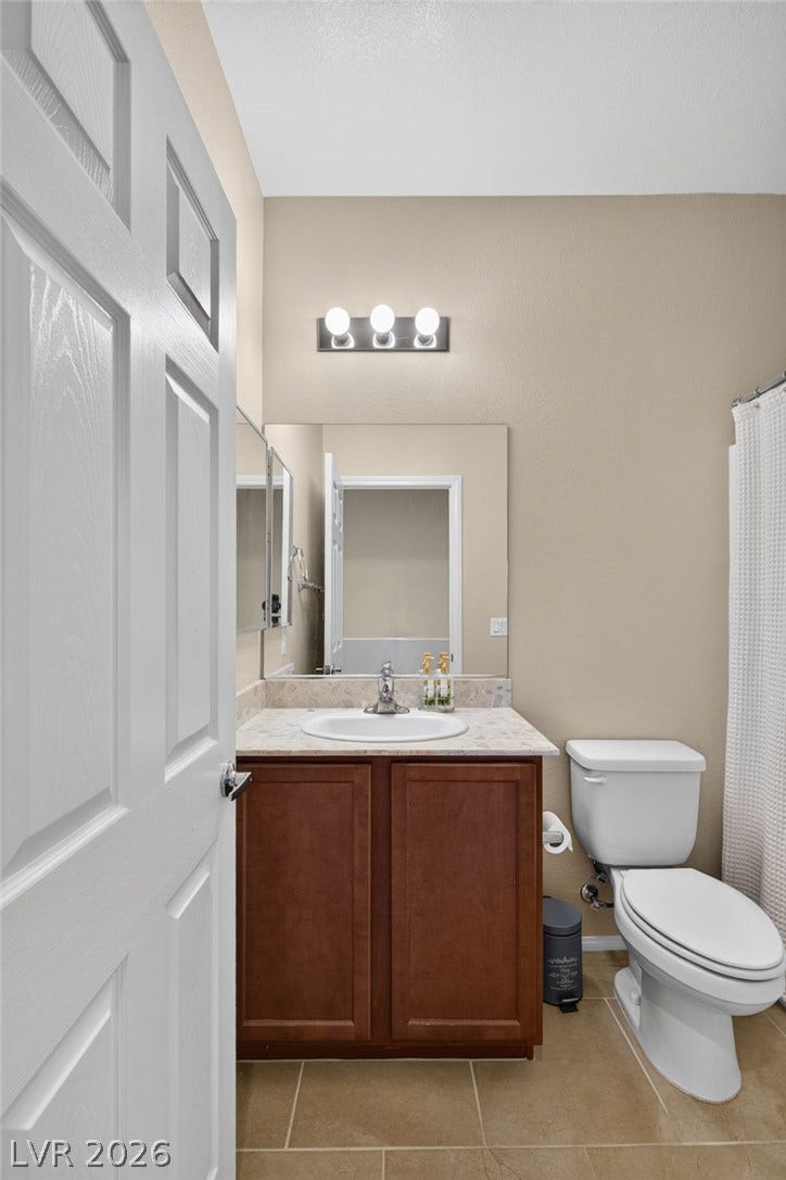 8112 Winterfell Place, Las Vegas, NV 89166 A single vanity with stone countertops highlights this functional secondary bathroom.