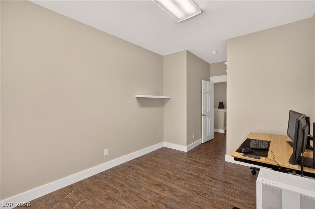 8112 Winterfell Place, Las Vegas, NV 89166 Rich wood flooring runs throughout this versatile workspace featuring clean architectural lines.