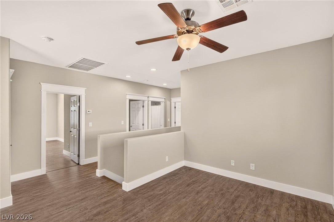 8112 Winterfell Place, Las Vegas, NV 89166 Gleaming hardwood floors and classic molding define this versatile upper-level landing space.