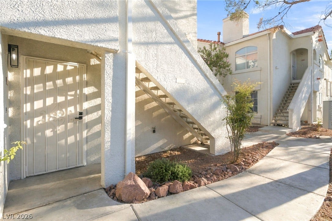 4500 W Lake Mead Boulevard, #102, Las Vegas, NV 89108 Stucco exteriors and concrete walkways define the entrance to this multi-level residential complex.