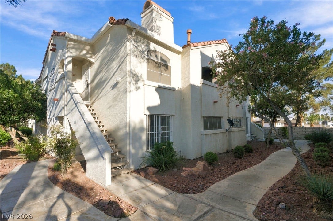 4500 W Lake Mead Boulevard, #102, Las Vegas, NV 89108 Spanish tile accents and structured pathways frame this classic multi-level stucco exterior.