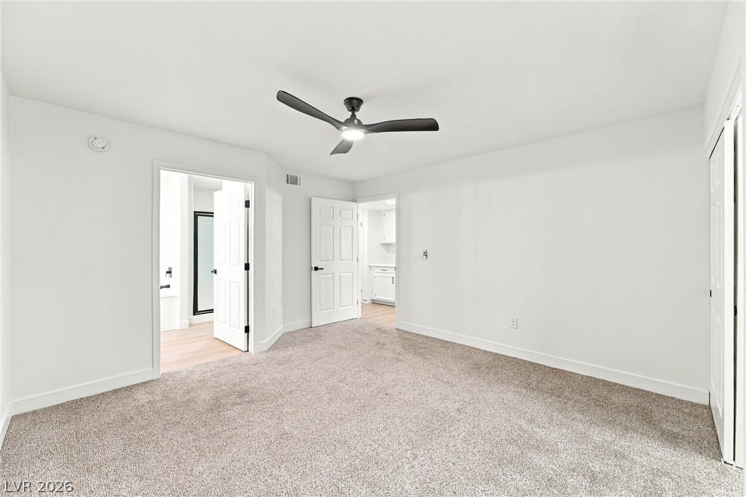4500 W Lake Mead Boulevard, #102, Las Vegas, NV 89108 Plush carpeting and crisp white walls define this comfortable bedroom space.