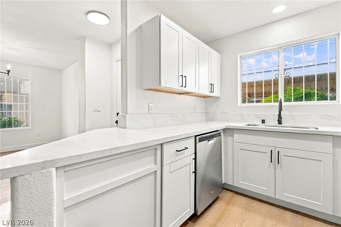 4500 W Lake Mead Boulevard, #102, Las Vegas, NV 89108 Crisp white cabinetry paired with durable countertops highlights this modern cooking space.
