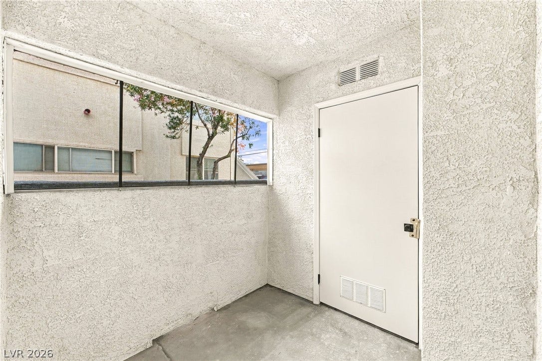 4500 W Lake Mead Boulevard, #102, Las Vegas, NV 89108 A private covered entryway features durable concrete flooring and a textured stucco finish.