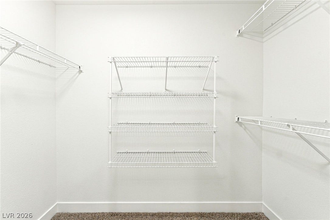 4500 W Lake Mead Boulevard, #102, Las Vegas, NV 89108 Ample wire shelving lines this functional closet space completed by soft carpeting.