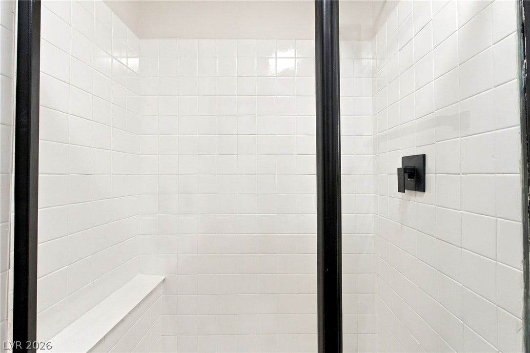 4500 W Lake Mead Boulevard, #102, Las Vegas, NV 89108 Clean lines and classic tiles define this enclosed walk-in shower design.