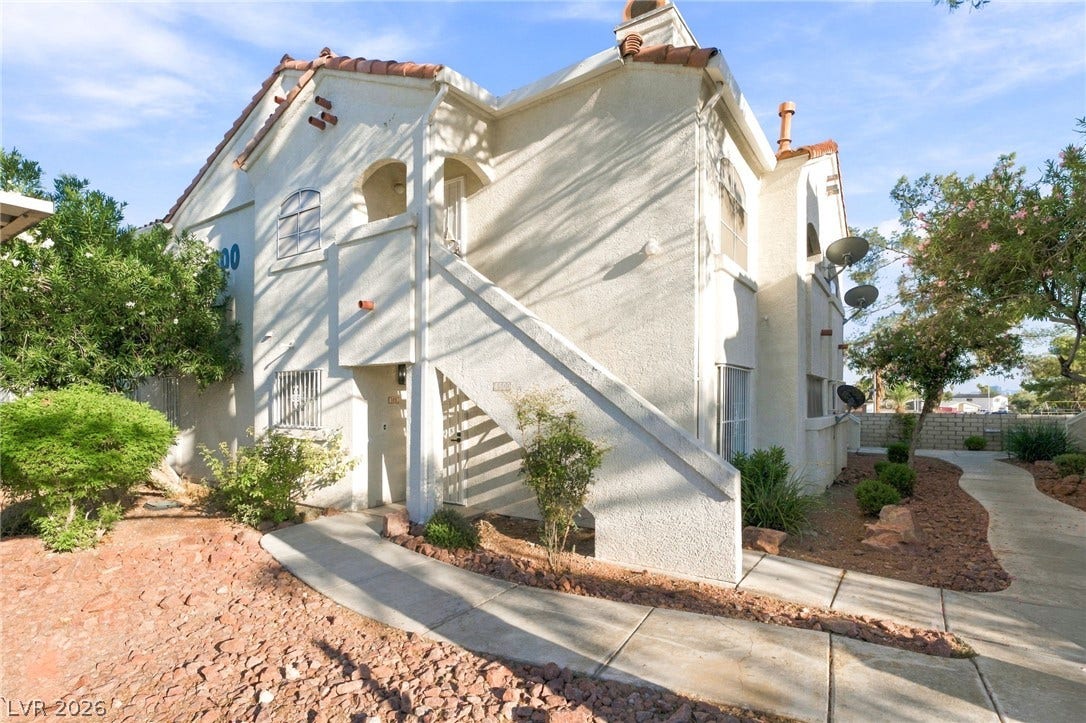 4500 W Lake Mead Boulevard, #102, Las Vegas, NV 89108 Spanish tile accents and a textured stucco exterior define this multi-level residential structure.