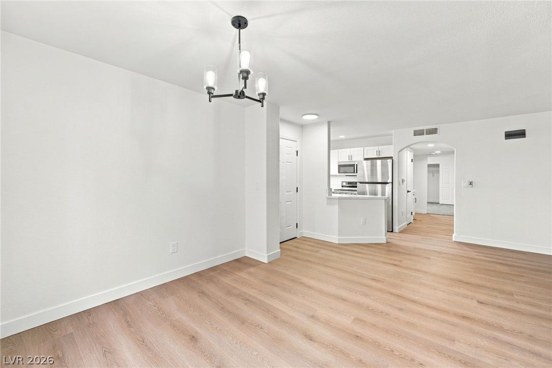 4500 W Lake Mead Boulevard, #102, Las Vegas, NV 89108 Smooth wood flooring and a modern light fixture enhance this open living layout.