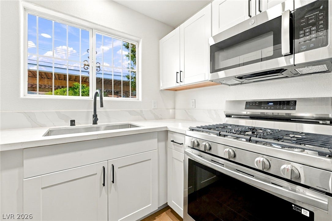 4500 W Lake Mead Boulevard, #102, Las Vegas, NV 89108 Crisp white cabinetry pairs perfectly with stone countertops in this modern workspace.