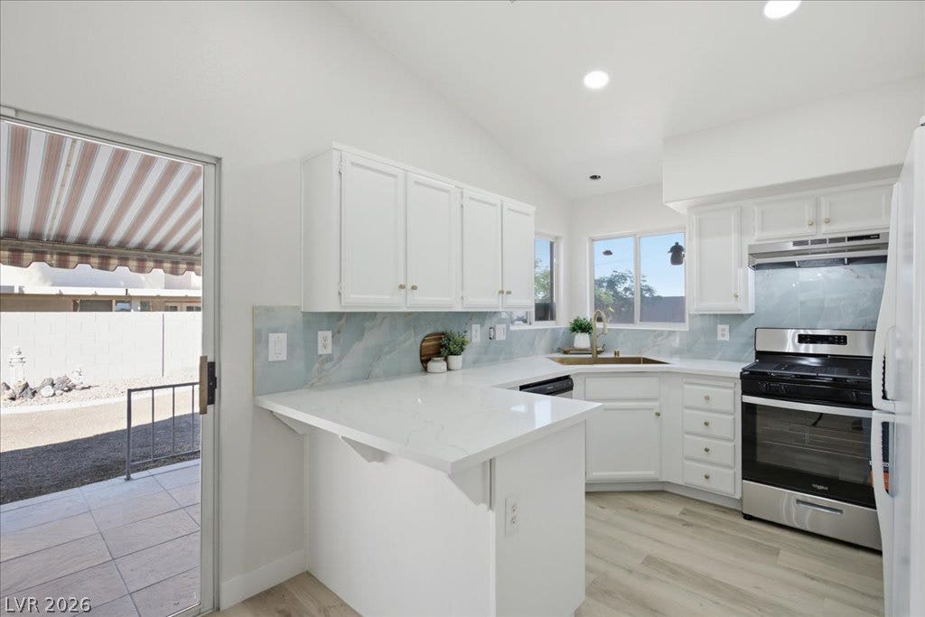 Sliding glass doors open directly to the patio from this modern kitchen space.