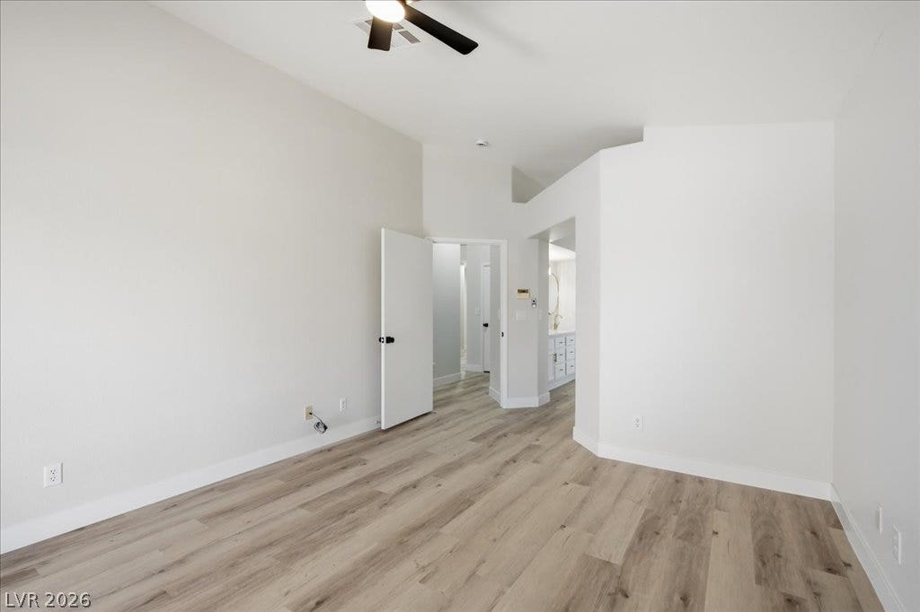High ceilings and clean wood-plank flooring define this modern primary suite retreat.