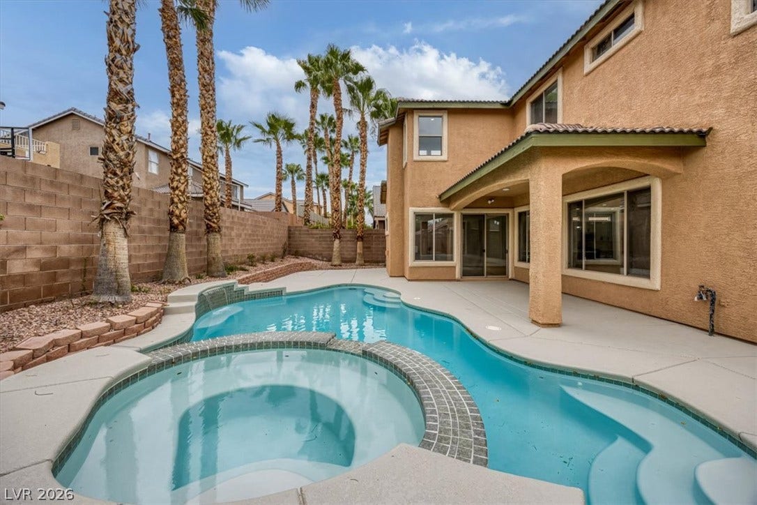 An inviting backyard oasis awaits with a sparkling pool and spa, perfect for relaxation and entertainment.