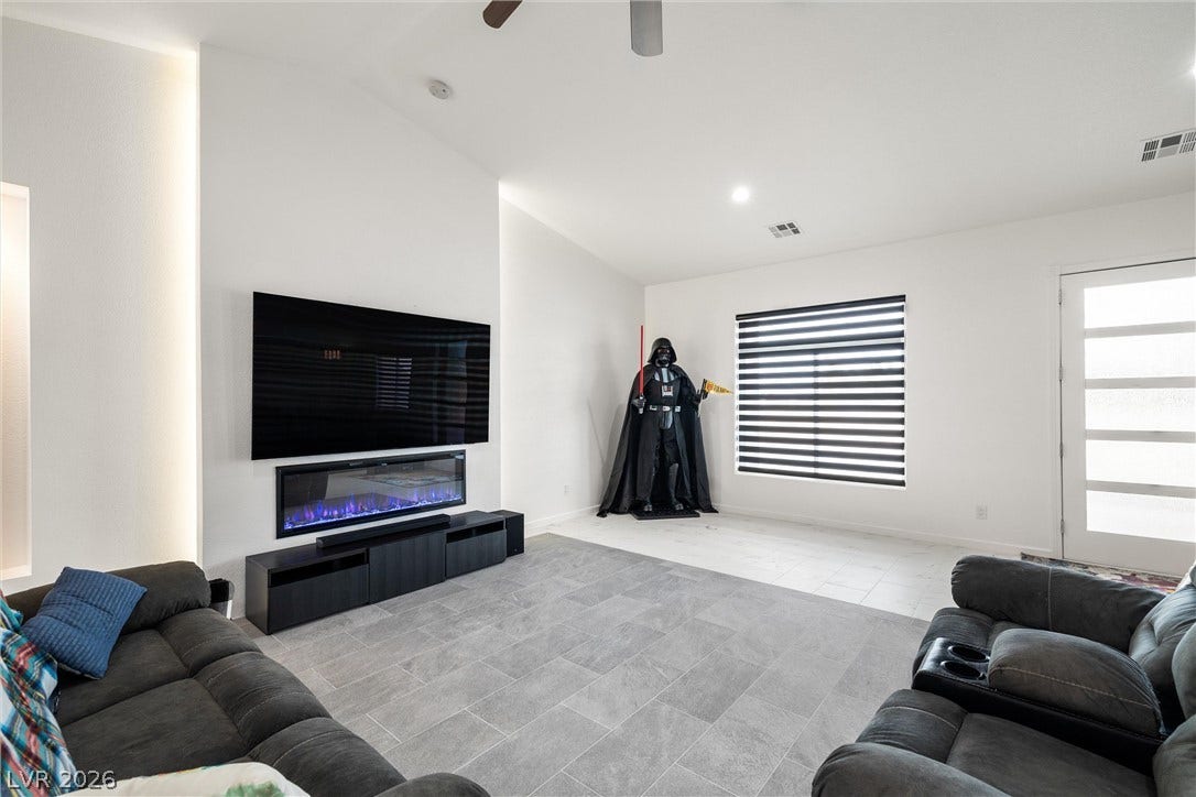 1601 W Calvada Boulevard, Pahrump, NV 89048 Clean lines and a modern electric, back-lit fireplace define this open living area