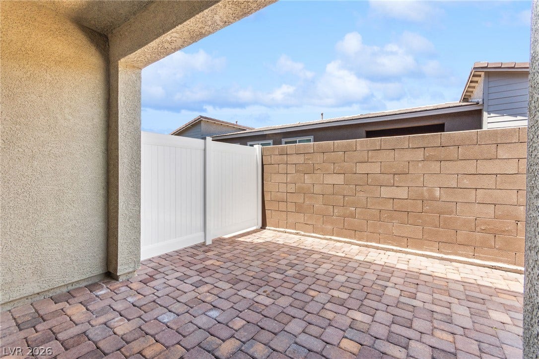 A private, paver-lined courtyard awaits, perfect for outdoor relaxation or entertaining.