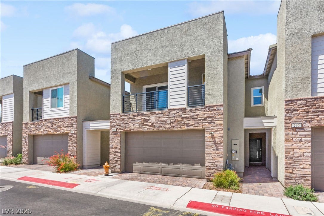 A modern facade with stacked stone accents and a private balcony enhances curb appeal.