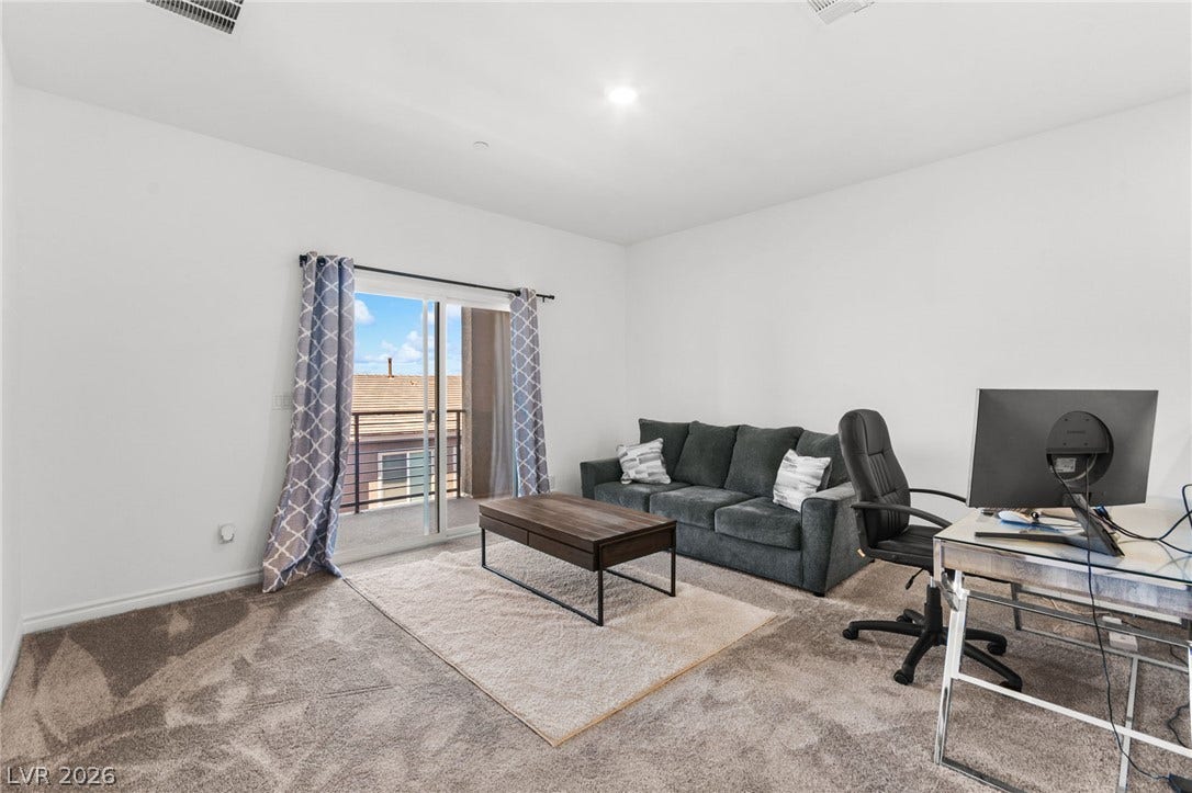 A well-lit sitting area with a comfortable sofa offers a serene space for relaxation or work.