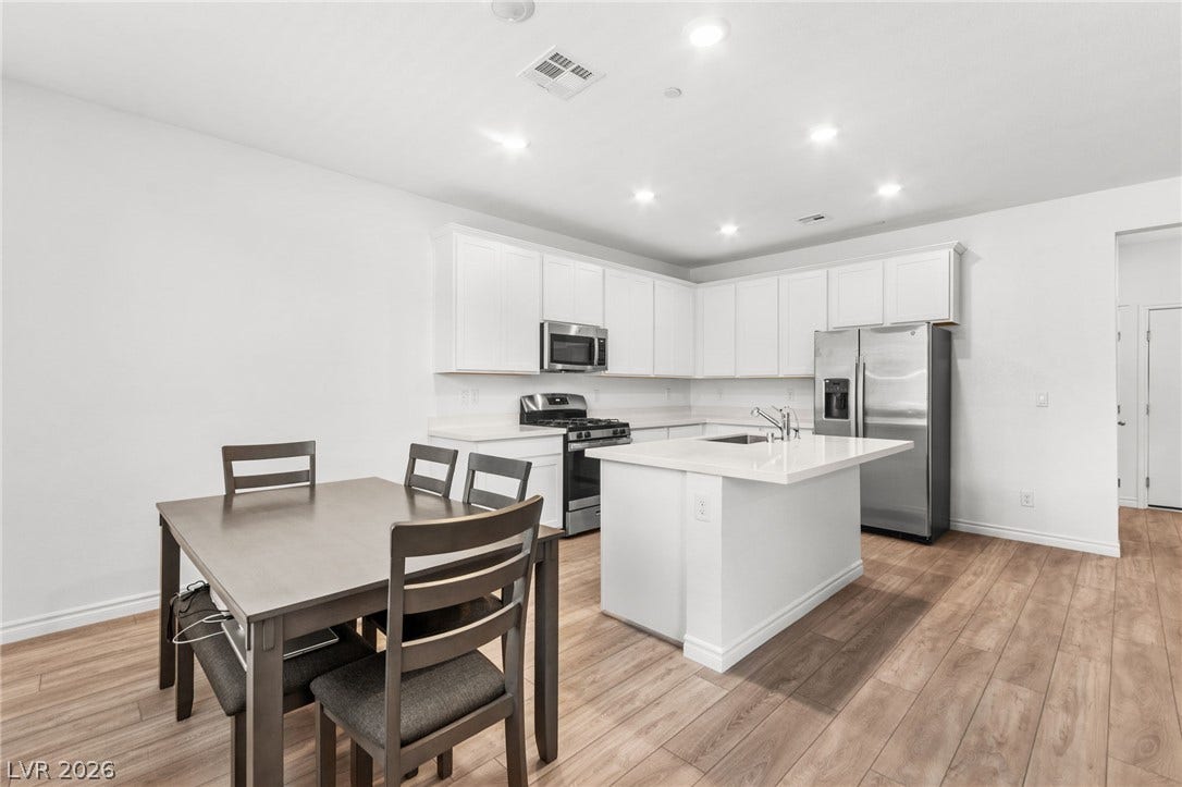 Culinary delights await in this bright kitchen, complete with a functional island and dining area.