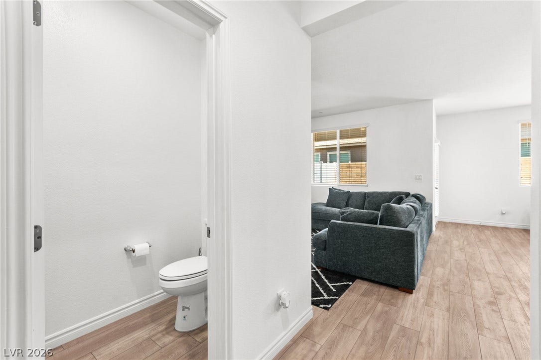 Streamlined hardwood floors extend through this well-lit living area, creating an inviting space.