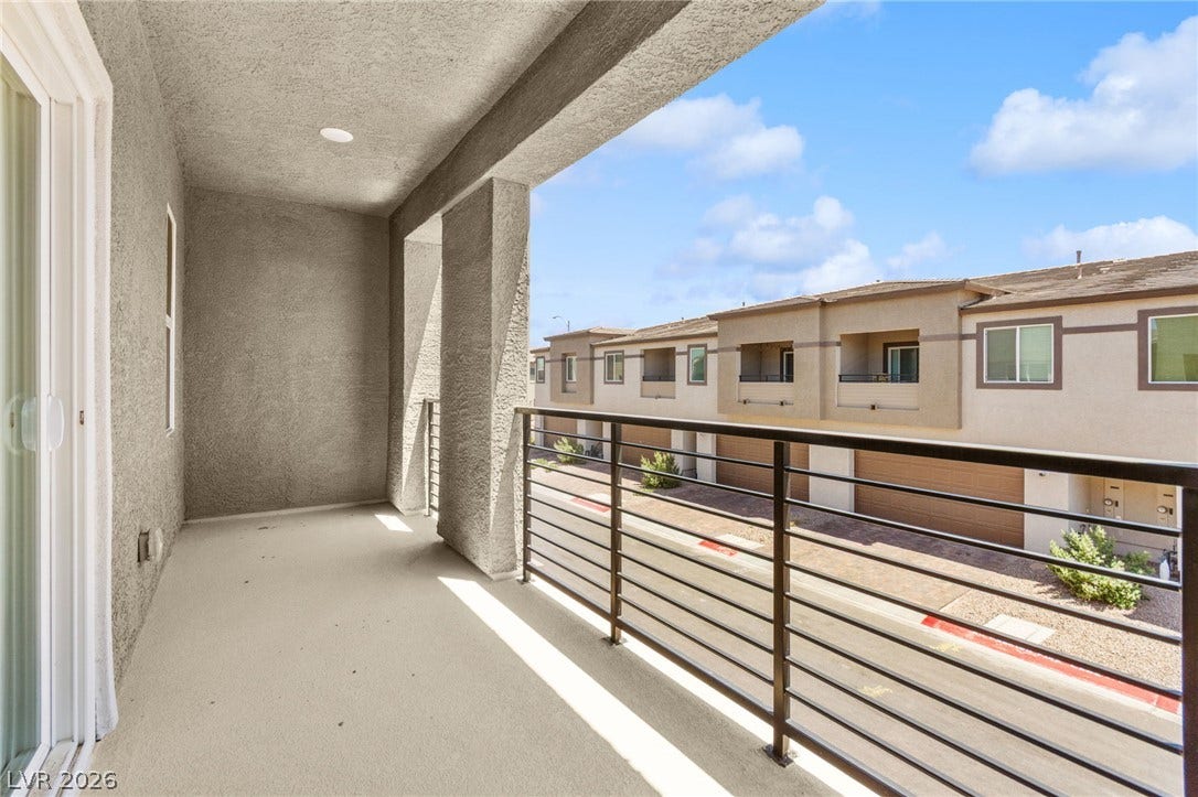 Step onto this private balcony for a refreshing outdoor retreat with views of the neighborhood.