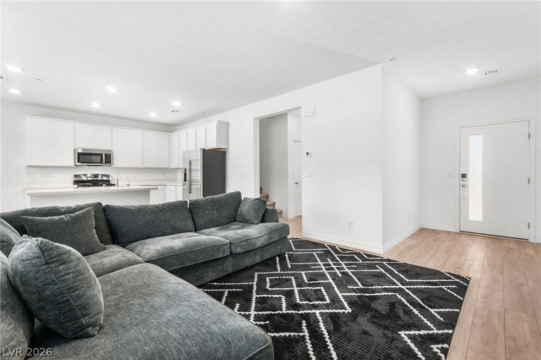 An open floorplan seamlessly connects the well-appointed kitchen with the spacious living area, ideal for daily living.