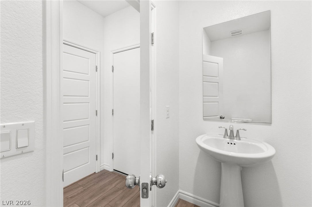A well-lit powder room offers clean lines and essential amenities for convenience.