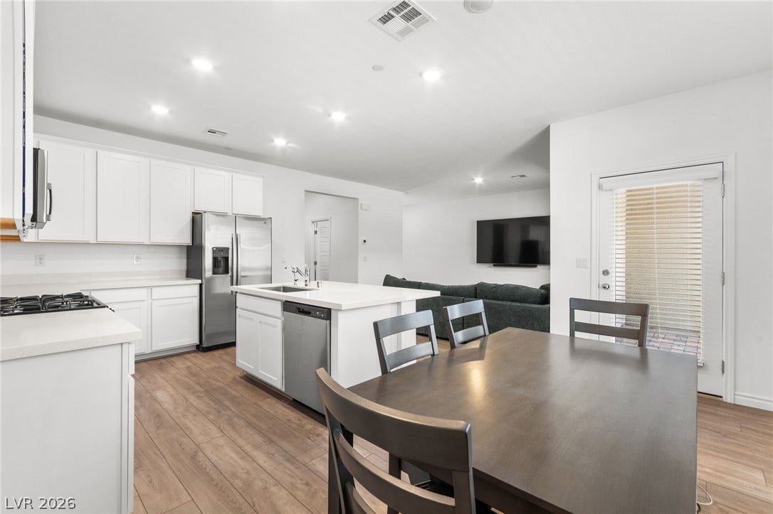 A well-appointed kitchen flows seamlessly into the inviting living area.