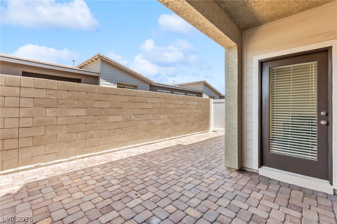 A private, paver-lined courtyard awaits, perfect for secluded outdoor enjoyment.