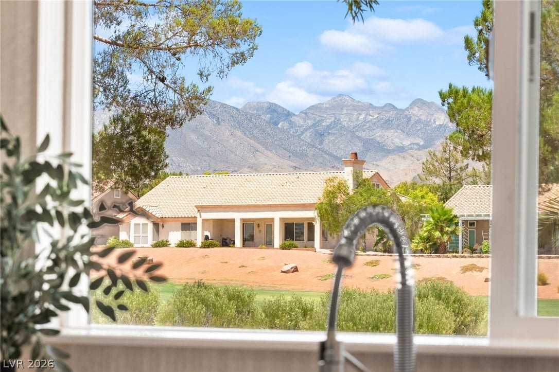 2641 Legend Drive, Las Vegas, NV 89134 Mountains rise behind a lovely residential home, showcasing the idyllic views from the property.