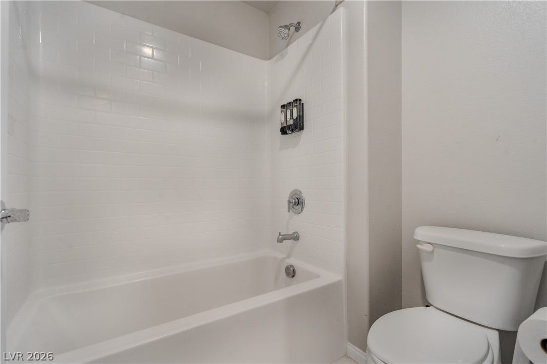 8920 Seal Cove Street, Las Vegas, NV 89178 A classic tiled shower and tub combination anchors this functional bathroom space.