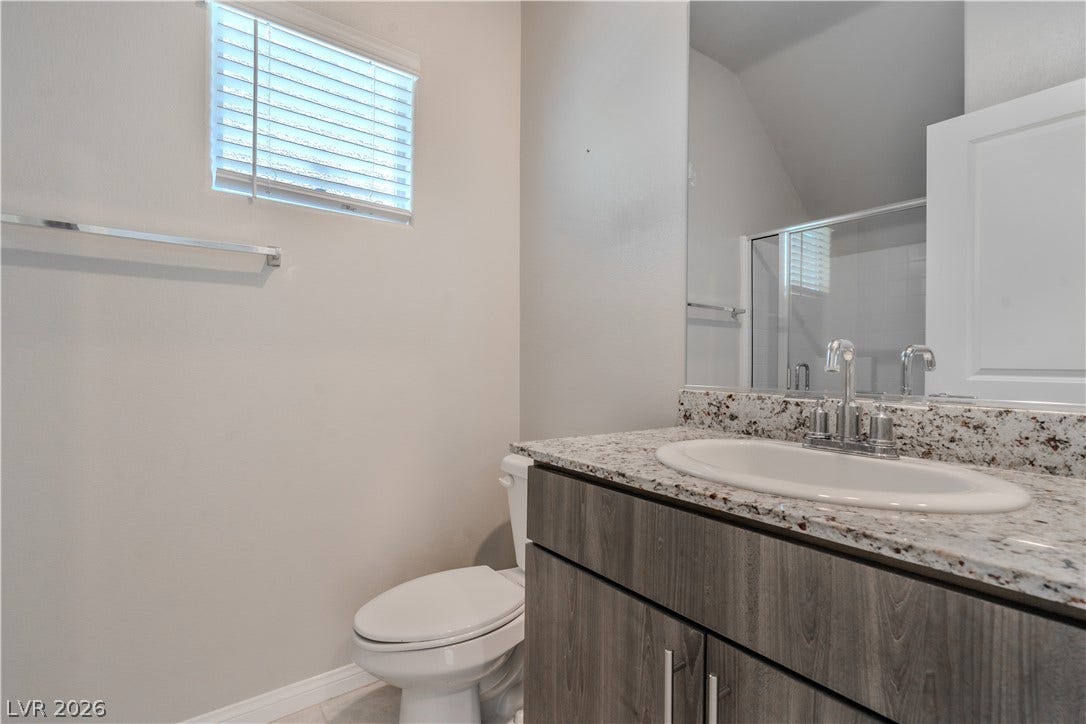 8920 Seal Cove Street, Las Vegas, NV 89178 **Downstairs bedroom**
Polished stone counters elevate the clean design of this modern bathroom.