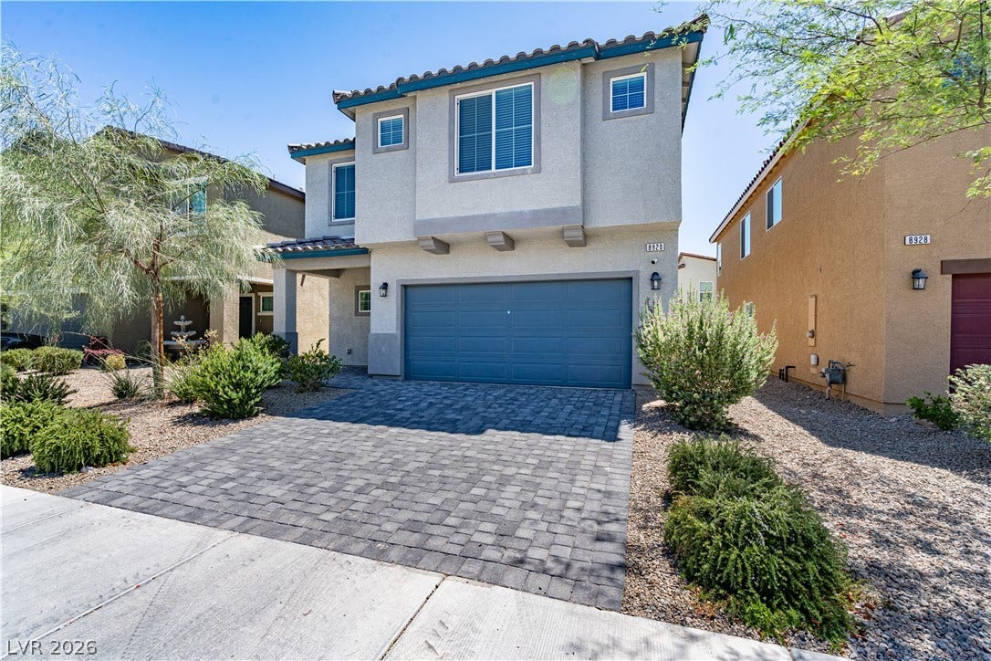 8920 Seal Cove Street, Las Vegas, NV 89178 Spanish tile accents and a pristine paver driveway enhance this contemporary two-story home.