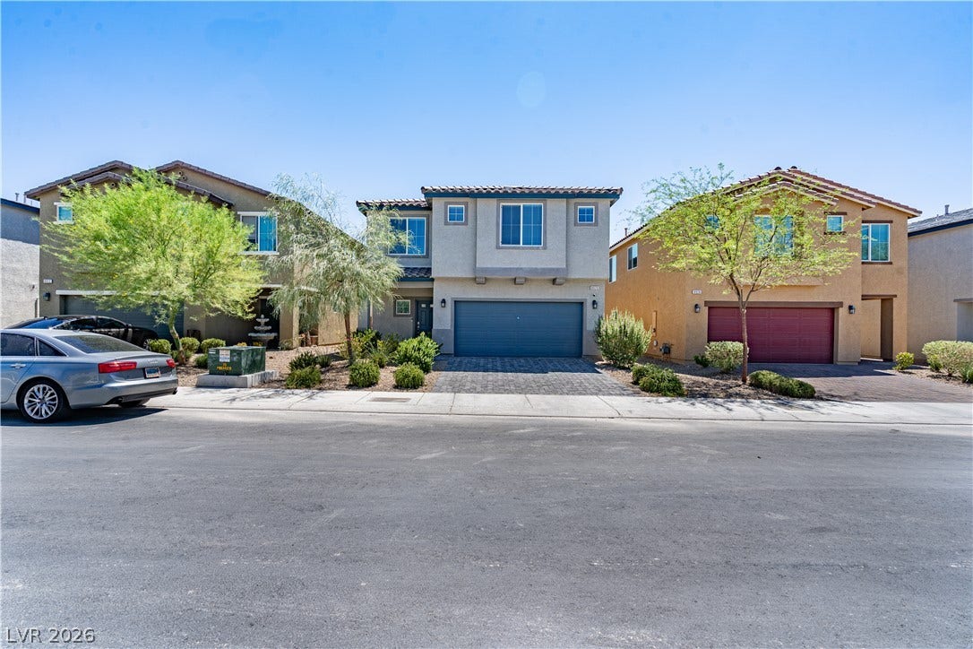 8920 Seal Cove Street, Las Vegas, NV 89178 Clean lines and a paved driveway define the exterior of this modern multi-level home.