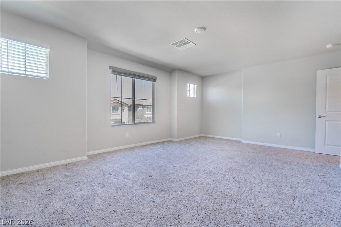 8920 Seal Cove Street, Las Vegas, NV 89178 Plentiful windows fill this carpeted living space with natural light.