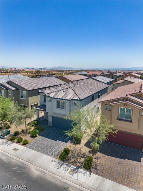 8920 Seal Cove Street, Las Vegas, NV 89178 A modern two-story home stands out with its paved driveway under a clear blue sky.