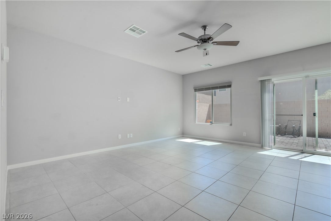 8920 Seal Cove Street, Las Vegas, NV 89178 Tiled floors and a sliding glass door accent this open living area.