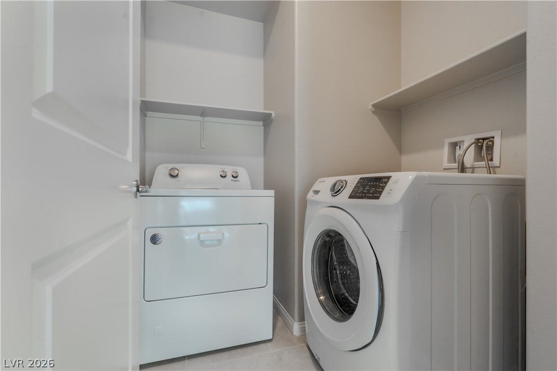 8920 Seal Cove Street, Las Vegas, NV 89178 **Downstairs**
Built-in shelving maximizes storage potential in this tidy laundry space.