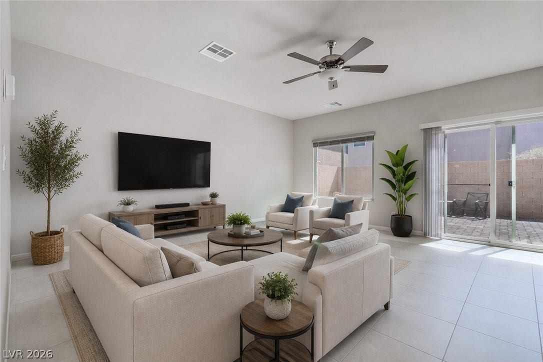 8920 Seal Cove Street, Las Vegas, NV 89178 **Virtually Staged**
Sliding glass doors open directly to the patio from this modern tiled living space.