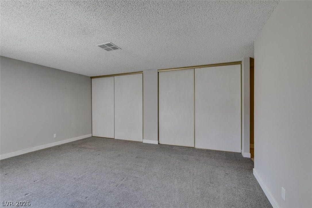 An airy bedroom with spacious closets awaits your personal touch.