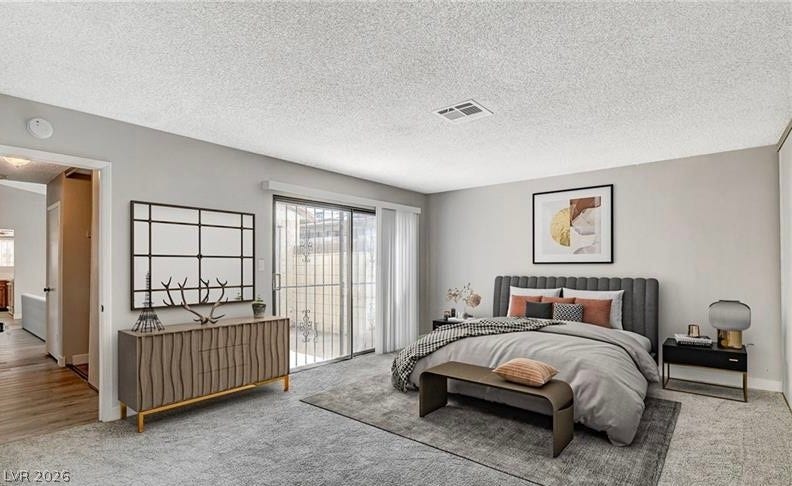 Sliding glass doors open onto a private outdoor space, creating an airy and adaptable sleeping area.