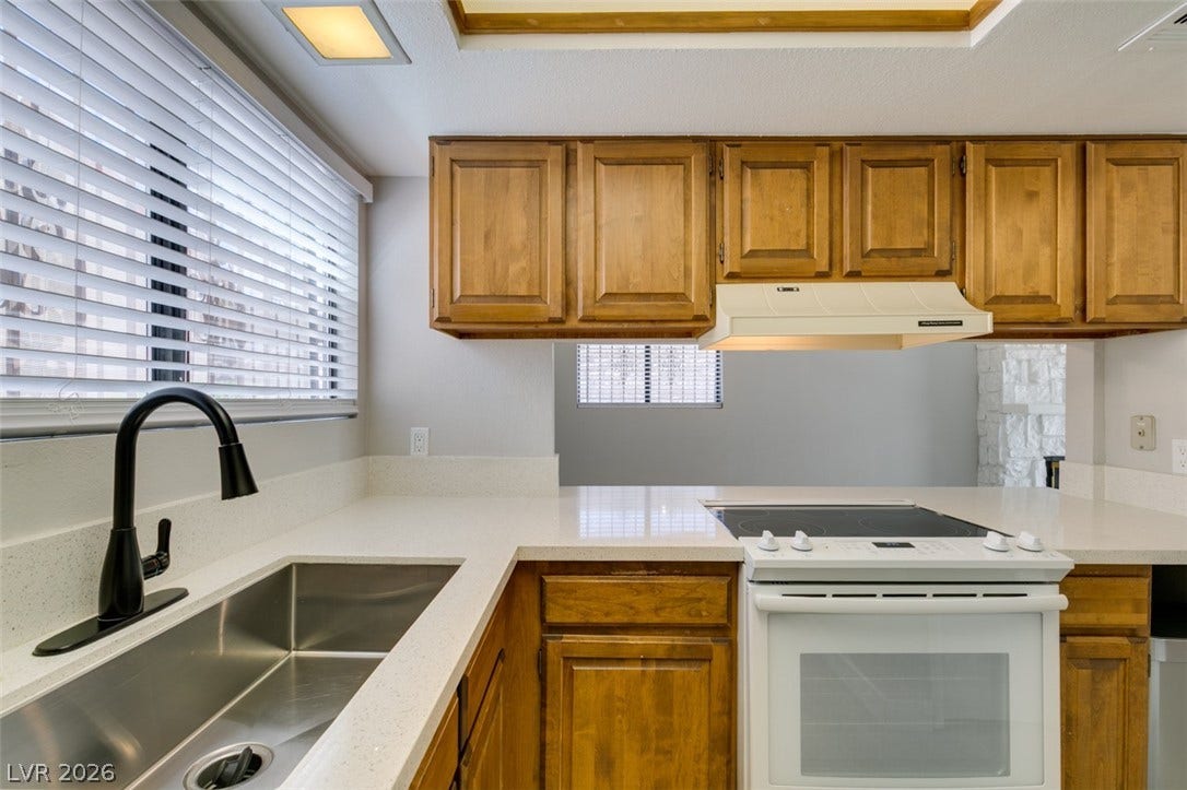 A well-appointed kitchen features ample counter space and essential appliances for everyday living.