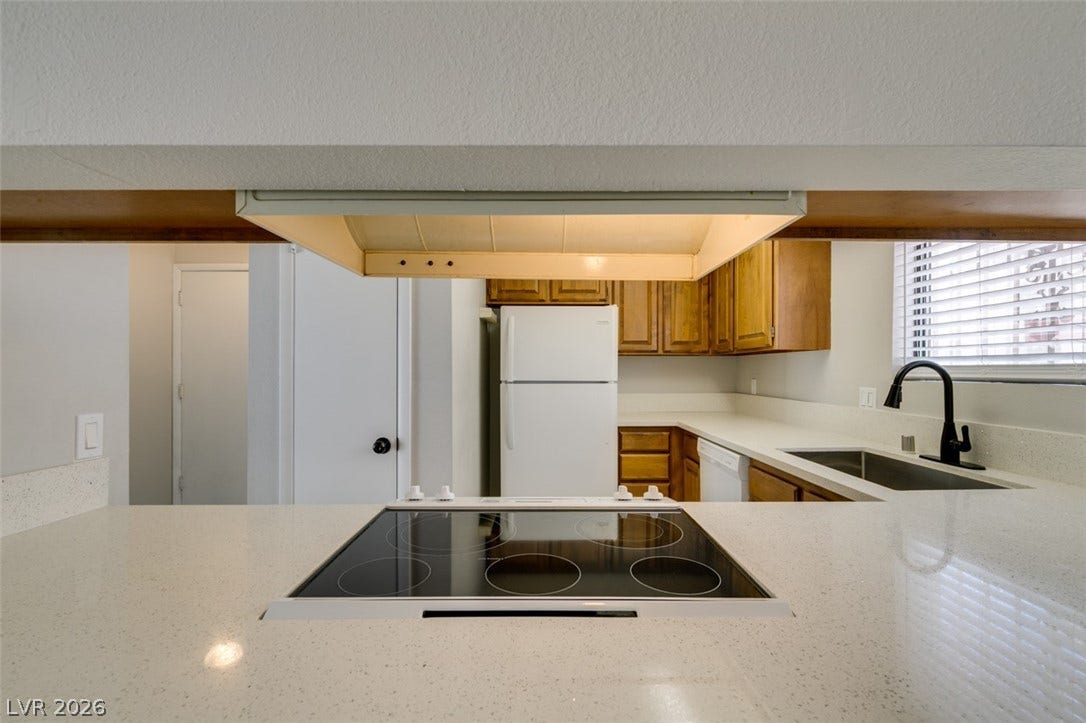 Culinary adventures await in this kitchen featuring abundant counter space and modern appliances.