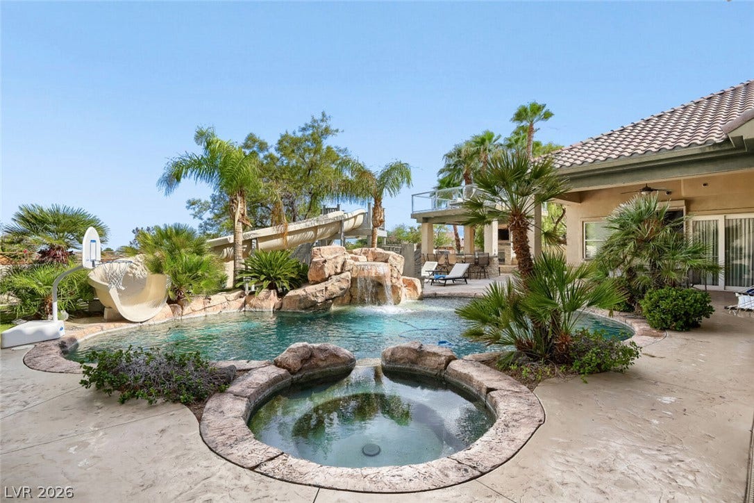 2010 Shenley Court, Las Vegas, NV 89117 An inviting backyard oasis features a custom rock waterfall pool paired with a matching integrated spa.