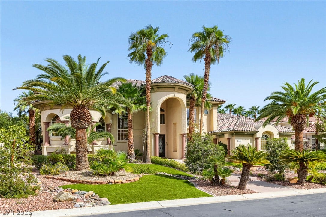 2010 Shenley Court, Las Vegas, NV 89117 Towering palm trees frame the grand arched entry of this elegant Spanish tile-roofed estate.